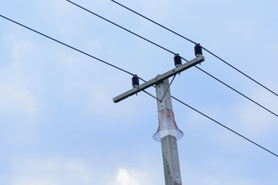 Low angle view of electricity pylon against sky