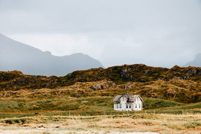 House on mountain against sky