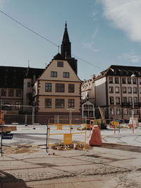 Houses by street in town against sky