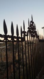 Fence against clear sky during sunset