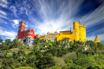 Panoramic view of trees and buildings against sky