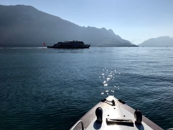 Boat sailing in sea against sky