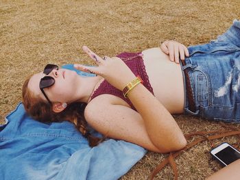 Midsection of woman lying on beach