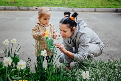 Spring gardening activities for toddler kids. senior woman grandmother and little toddler girl