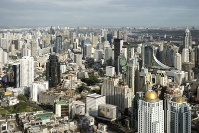 High angle view of modern buildings in city against sky