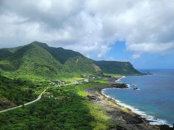 Scenic view of sea and mountains against sky