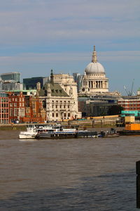 View of buildings at waterfront against sky