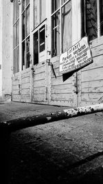 Text on footpath by building