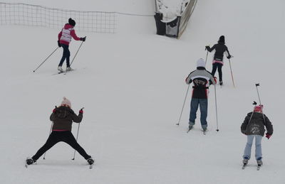 Full length of people skiing on snow