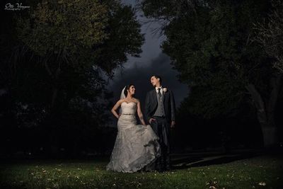 Full length of mother and daughter in park against trees at night