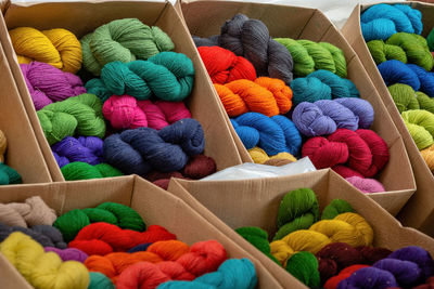 High angle view of multi colored wool balls in cardboard box