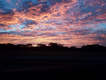 Scenic view of silhouette landscape against sky at sunset