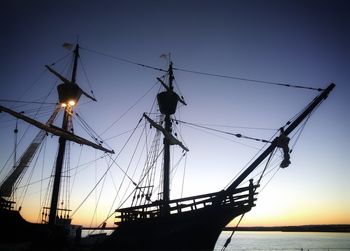 Low angle view of silhouette sailboat against sky at sunset