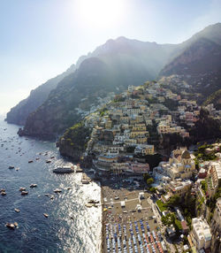 High angle view of townscape by sea against sky