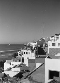 High angle view of city by sea against sky