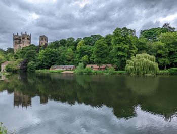 Scenic view of lake by trees against sky