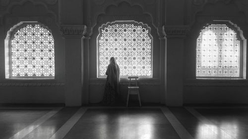 Monochrome photo of women standing in a corridor