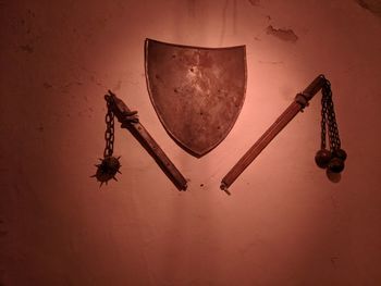 Low angle view of metal hanging against wall