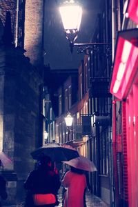 Man on illuminated street at night