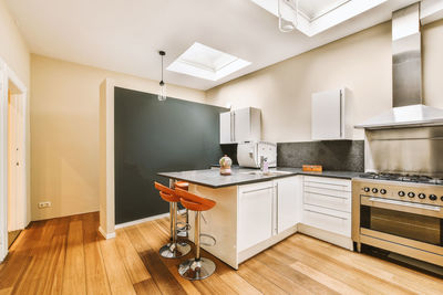 Low section of woman standing in kitchen