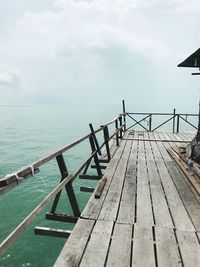 Jetty on sea against sky