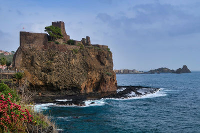 Historic building by sea against sky