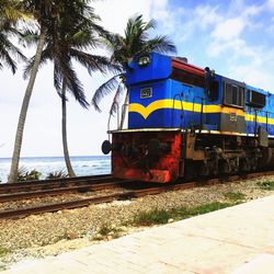 Train by sea against sky