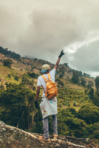 Full length of man standing by tree against sky