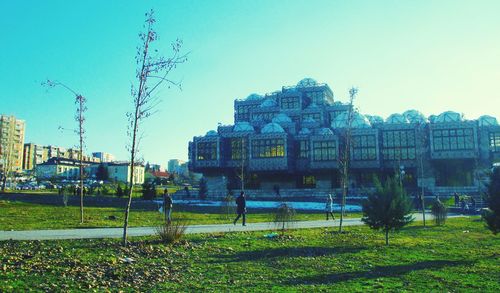 View of buildings against clear blue sky