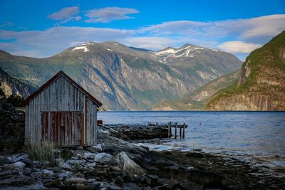 Scenic view of sea and mountains against sky