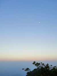 Scenic view of sea against clear sky at dusk