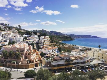 High angle view of townscape by sea against sky