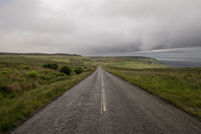 Road passing through landscape against sky