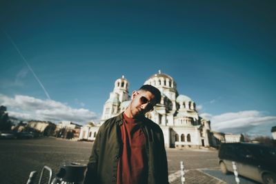 Man standing in front of historical building