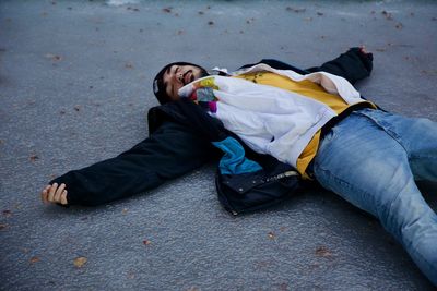 Man lying down on road