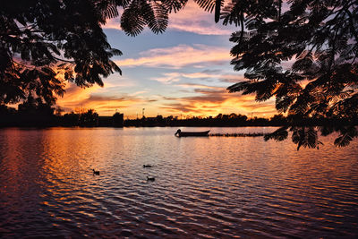 Scenic view of lake against sky during sunset