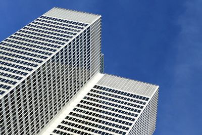 Low angle view of modern buildings against clear blue sky