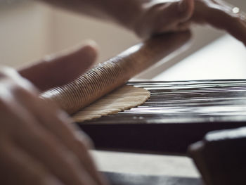 Close-up of hands playing piano