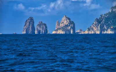 Panoramic view of sea and rock formation against sky