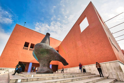 Low angle view of statue against building