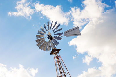 Low angle view of traditional windmill against sky