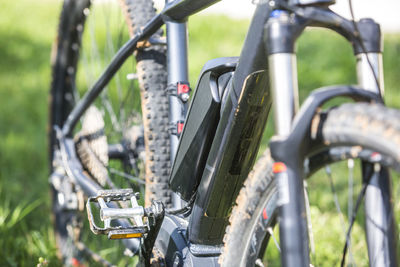 Close-up of bicycle parked on field