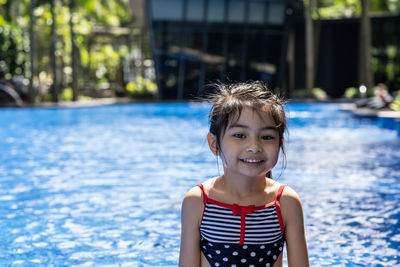 Portrait of girl by swimming pool