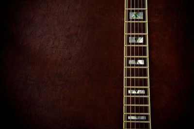 Cropped image of guitar fretboard