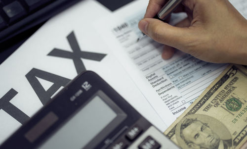 Cropped hand of businessman working in office