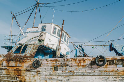 Low angle view of abandoned ship against clear sky