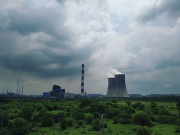 View of factory against cloudy sky