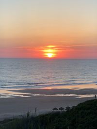 Scenic view of sea against romantic sky at sunset