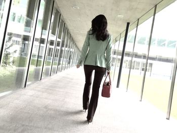 Full length of woman standing by railing