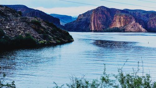 Scenic view of lake and mountains against sky